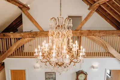 a chandelier hanging from a ceiling in a room at Creeksea Place Barns in Burnham on Crouch