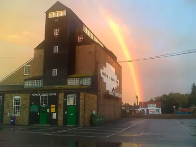 a rainbow is in the sky over a building at Frasers in Battlesbridge