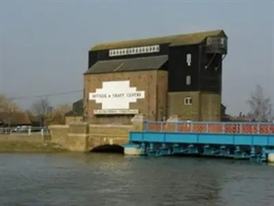 a building on the side of a body of water at Frasers in Battlesbridge