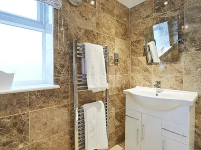 a bathroom with a sink and a mirror at The Rose and Crown in Thorpe le Soken