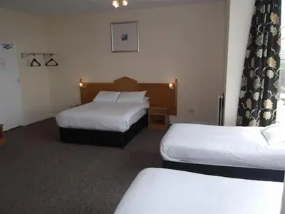 a hotel room with two beds in a room at Esplanade Hotel - Clacton On Sea, Beachfront Hotel by OYO in Clacton-on-Sea