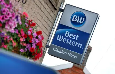 a sign for a best western hotel next to flowers at Best Western Claydon Hotel in Ipswich