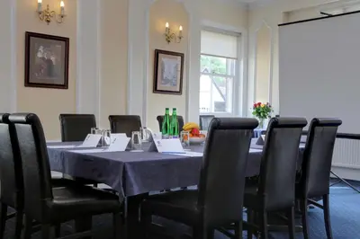 a dining room with a table with chairs and a table cloth at Best Western Claydon Hotel in Ipswich