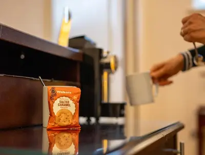 a person is making a box of cookie biscuits at County Hotel in Chelmsford