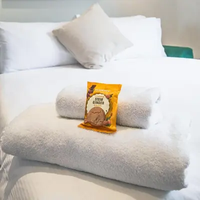 a pile of towels sitting on top of a bed at County Hotel in Chelmsford