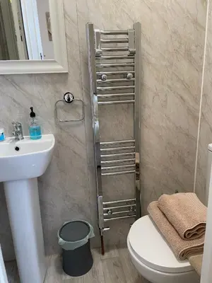 a bathroom with a toilet and a sink at CARIS Guest House in Southend-on-Sea
