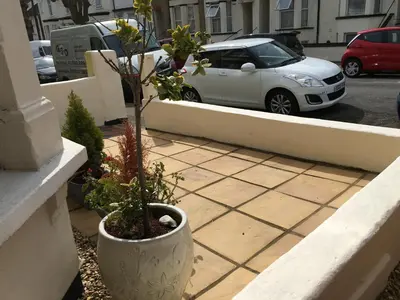 a plant in a pot sitting on a ledge at CARIS Guest House in Southend-on-Sea