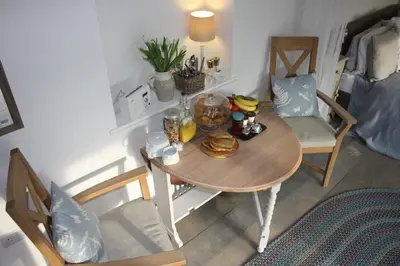 a table with a bowl of food on top of a room at Crafts Hill Barn in Cambridge