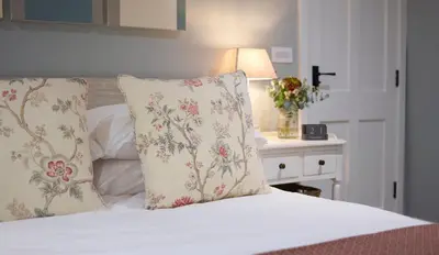 a bedroom with a bed with two pillows on it at The Three Hills in Bartlow