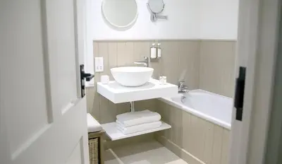 a bathroom with a sink and a bath tub at The Three Hills in Bartlow