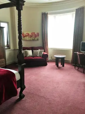 a living room with a couch and a table at Old Bull Inn in Royston