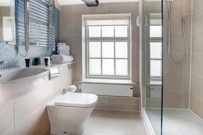 a bathroom with a toilet and a sink and a shower at Cambridge Quy Mill Hotel & Spa in Cambridge