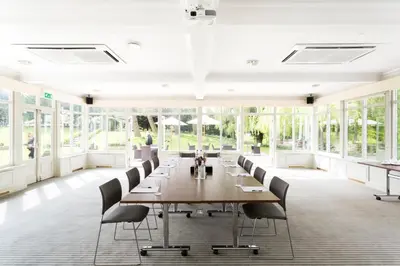 a large conference room with a long table and chairs at Cambridge Quy Mill Hotel & Spa in Cambridge