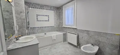 a bathroom with a sink and a tub and a toilet at Manor Of Groves Hotel, Golf & Health Club in Sawbridgeworth