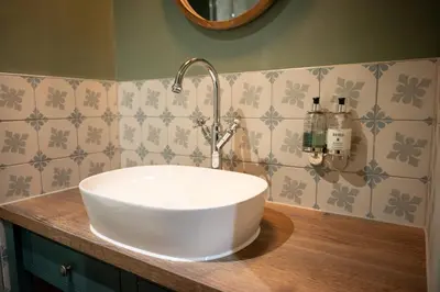 a bathroom with a white sink on a counter at Green Man by Chef & Brewer Collection in Harlow