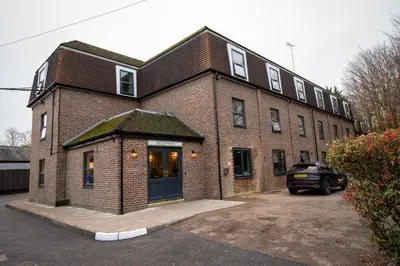 a brick building with a car parked in front of it at Green Man by Chef & Brewer Collection in Harlow