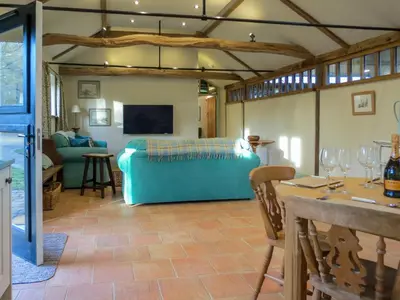 a living room with a couch and a table at Appletree Cottage Fressingfield in Fressingfield