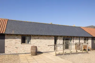 a brick building with a black roof at Clopton Courtyard Cambridge in Cambridge