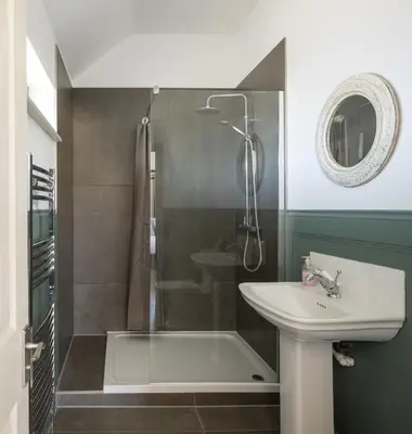 a bathroom with a shower and a sink and a tub at Clopton Courtyard Cambridge in Cambridge