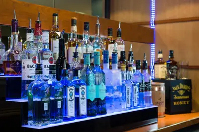 a display of bottles of alcohol on a shelf at Holiday Inn Express Cambridge by IHG in Cambridge