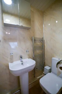 a bathroom with a sink and a toilet at Fennec Apartments in Cherry Hinton