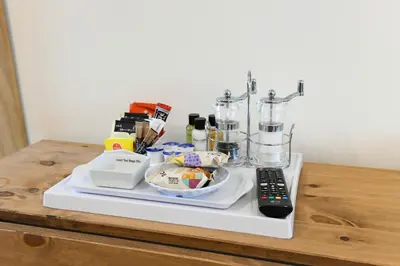 a counter with a blender and a remote control at Fennec Apartments in Cherry Hinton