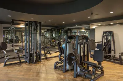 a gym with a bunch of treadmills and machines at Cambridge Belfry Hotel & Spa in Cambridge