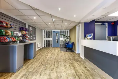 an empty lobby of a store with a counter at Days Inn London Stansted Airport in Stansted Mountfitchet