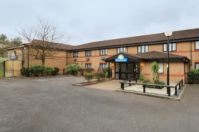 an empty parking lot in front of a building at Days Inn London Stansted Airport in Stansted Mountfitchet