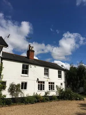a white house with a chimney on top of it at Old Rectory - Scoulton in Great Ellingham