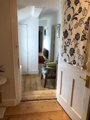 a hallway with an open door to a living room at Old Rectory - Scoulton in Great Ellingham