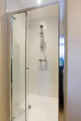 a shower with a glass door in a bathroom at The Retreat, Unique property located in calming woodland surroundings, Close to Aldeburgh and Thorpeness in Leiston