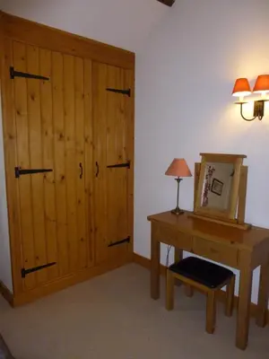 a room with a desk and a large closet at Golden Cross in Mendham