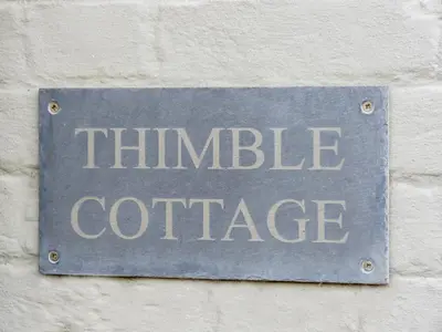 a sign that reads thinkle coffee on a wall at Thimble Cottage - Aldeburgh Coastal Cottages in Aldeburgh