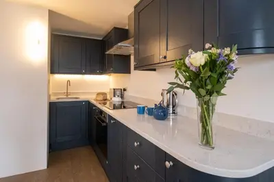 a kitchen with a vase of flowers on a counter at Boat Lake in Thorpeness