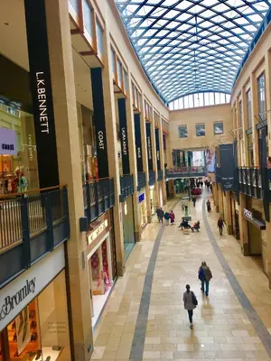 an empty shopping mall with people walking through it at Angel's (station accommodation) in Cambridge