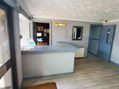 a restaurant with a blue counter in a room at The Oasis Hotel in Harlow