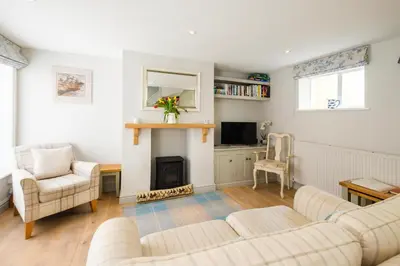 a living room with two couches and a fireplace at The Old Custom House in Aldeburgh