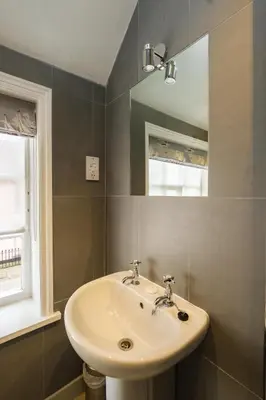 a bathroom with a sink and a mirror at The Old Custom House in Aldeburgh