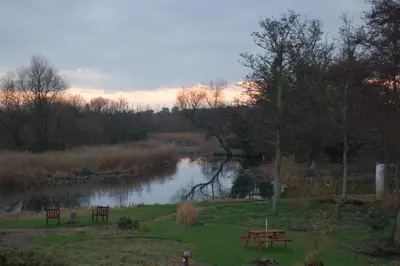 a park with a picnic table and a river at Thorpeness Golf Club and Hotel in Thorpeness