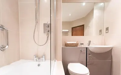 a bathroom with a shower and a toilet and a sink at Thorpeness Golf Club and Hotel in Thorpeness