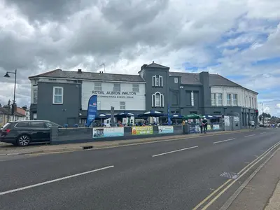 a building on the side of a road next to a street at Royal Albion Walton in Walton-on-the-Naze