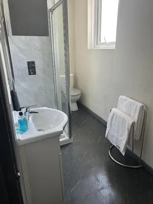 a bathroom with a sink and a toilet and a mirror at Royal Albion Walton in Walton-on-the-Naze