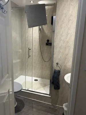 a shower with a glass door in a bathroom at Royal Albion Walton in Walton-on-the-Naze