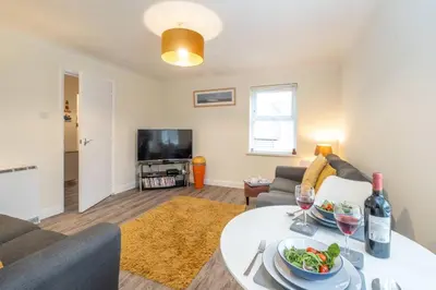 a living room with a table with a bowl of food at 17 Britten Close - Aldeburgh Coastal Cottages in Aldeburgh