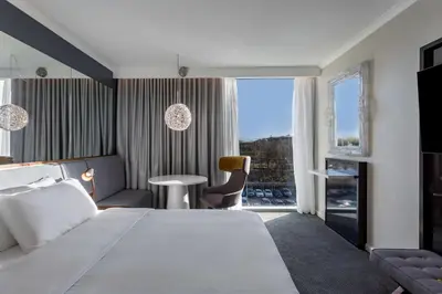 a hotel room with a large bed and a window at Radisson Blu Hotel London Stansted Airport in Stansted Mountfitchet