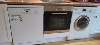 a kitchen with a dishwasher and a washing machine at Shear Annexe Flat in Cambridge