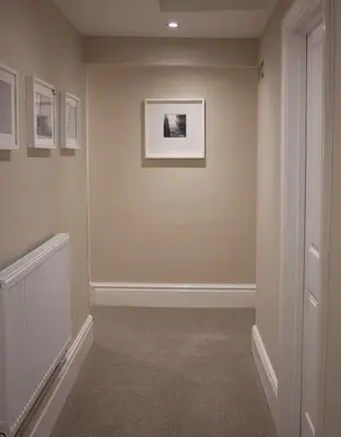 a hallway with paintings on the walls of a room at The Swan Hotel Bar and Grill in Maldon
