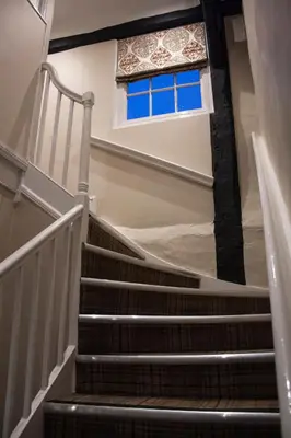 a set of stairs with a window in a building at The Swan Hotel Bar and Grill in Maldon