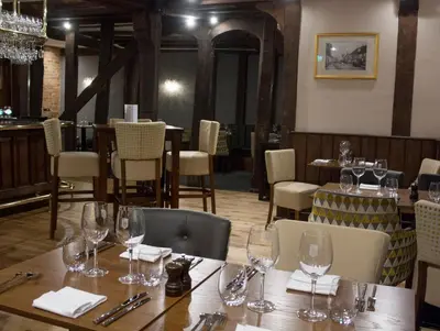 a dining room with a table with wine glasses on it at The Swan Hotel Bar and Grill in Maldon